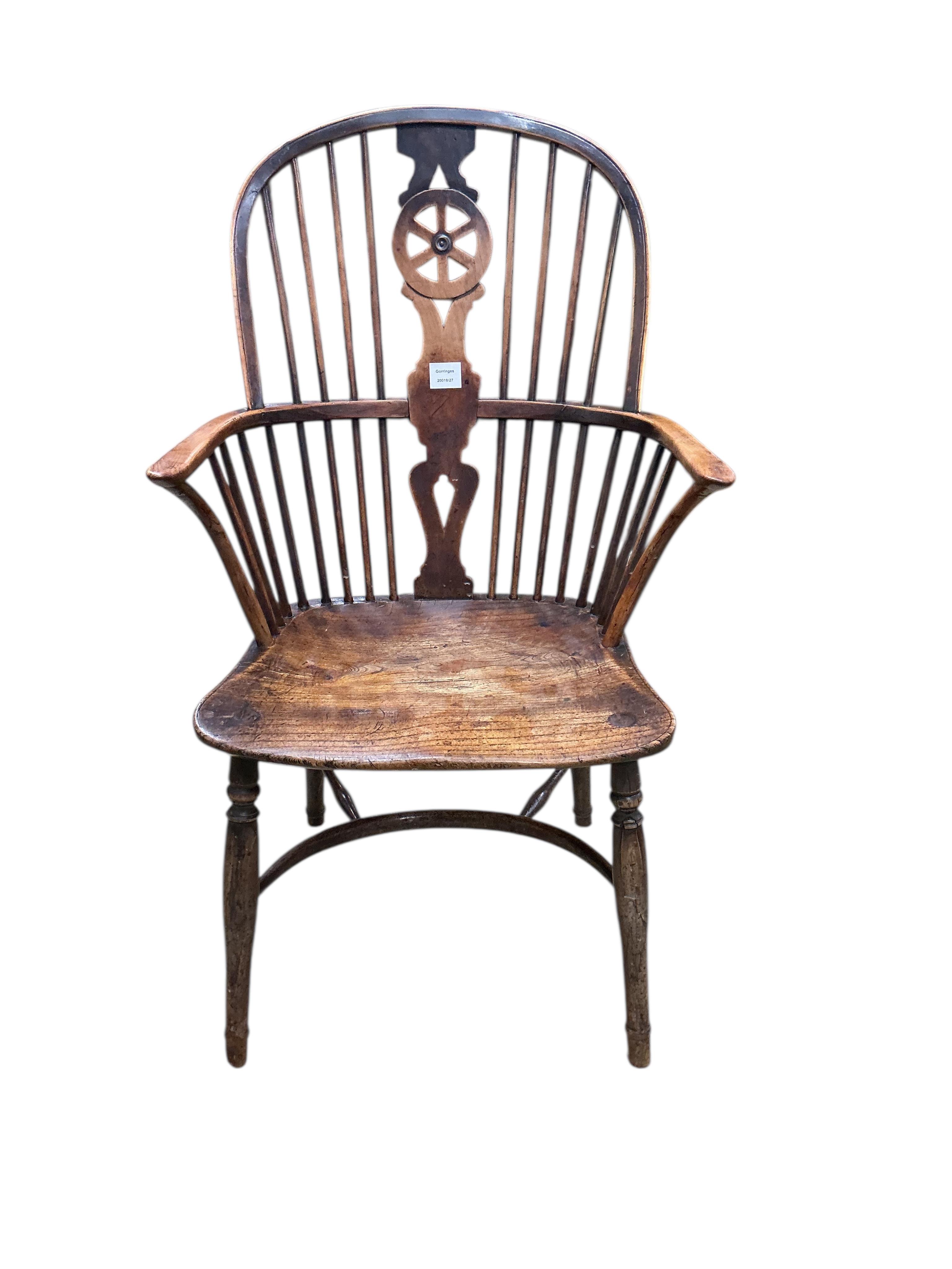 A 19th century yew and elm Windsor wheelback armchair with crinoline stretcher, width 58cm, depth 42cm, height 100cm